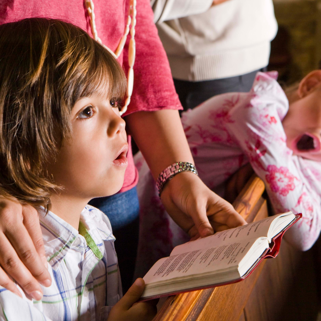 2 small kids with mom at Mass