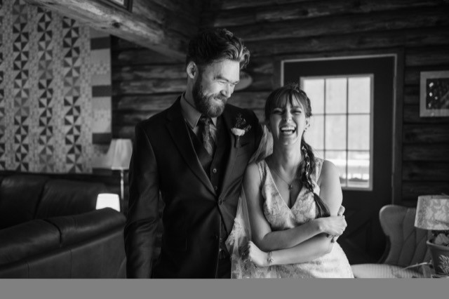 couple standing together inside log cabin