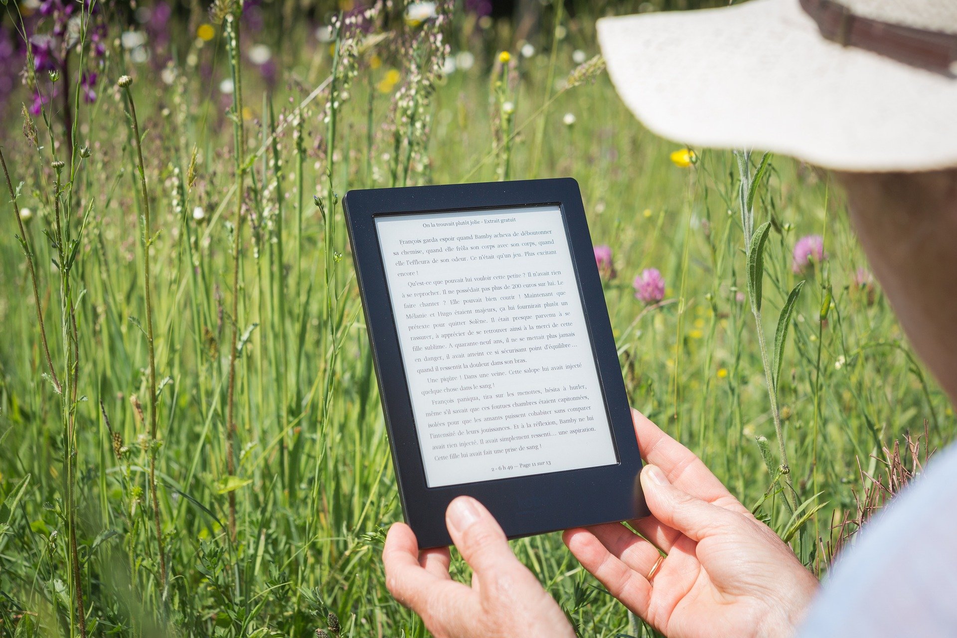 Person using e-reader outdoors