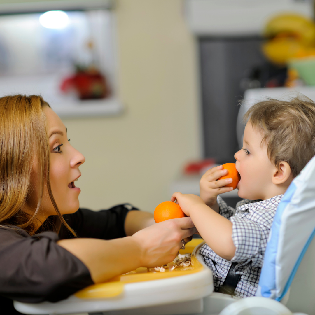 mother with toddler in high chair