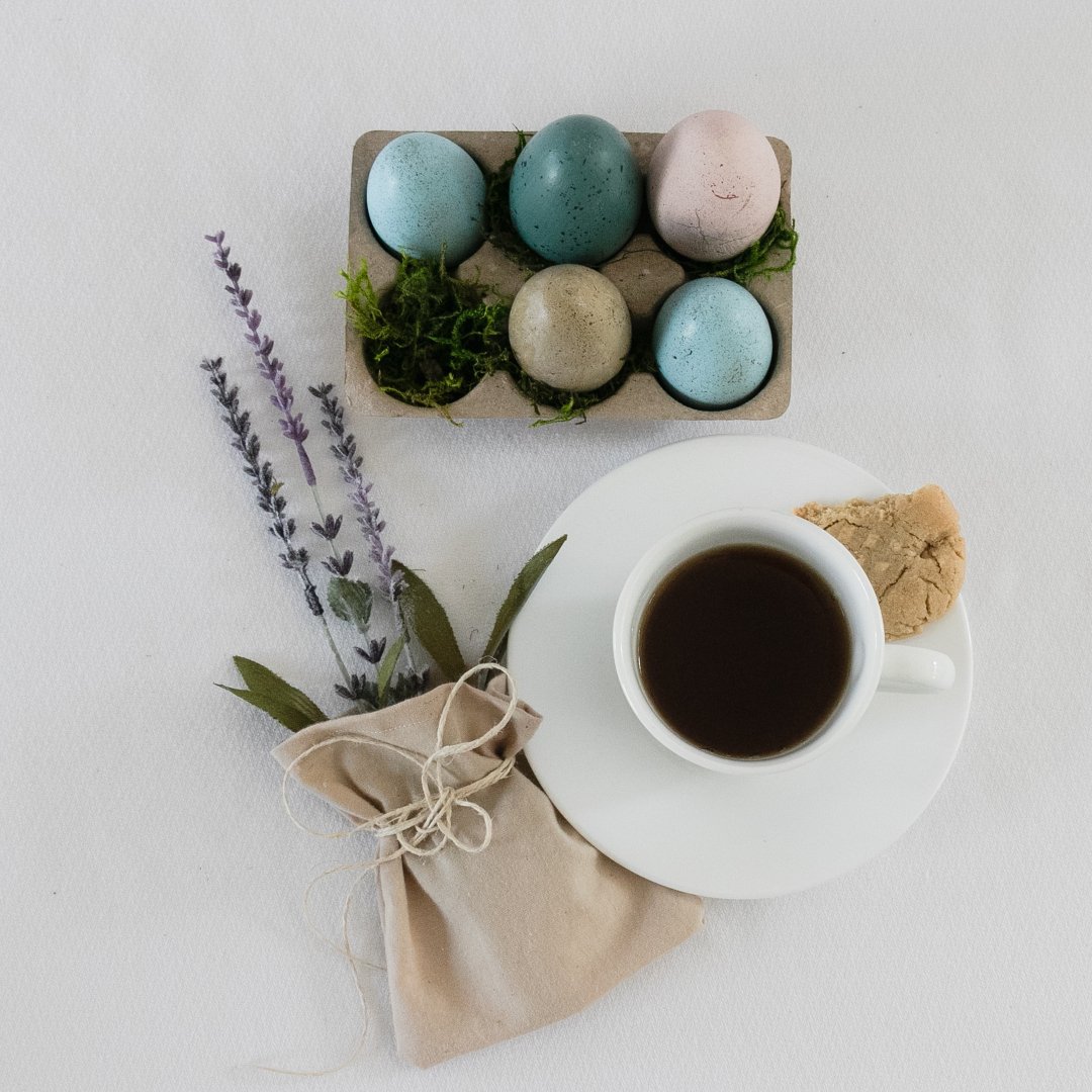 Easter eggs, bunch of lavender, cup of coffee and cookie