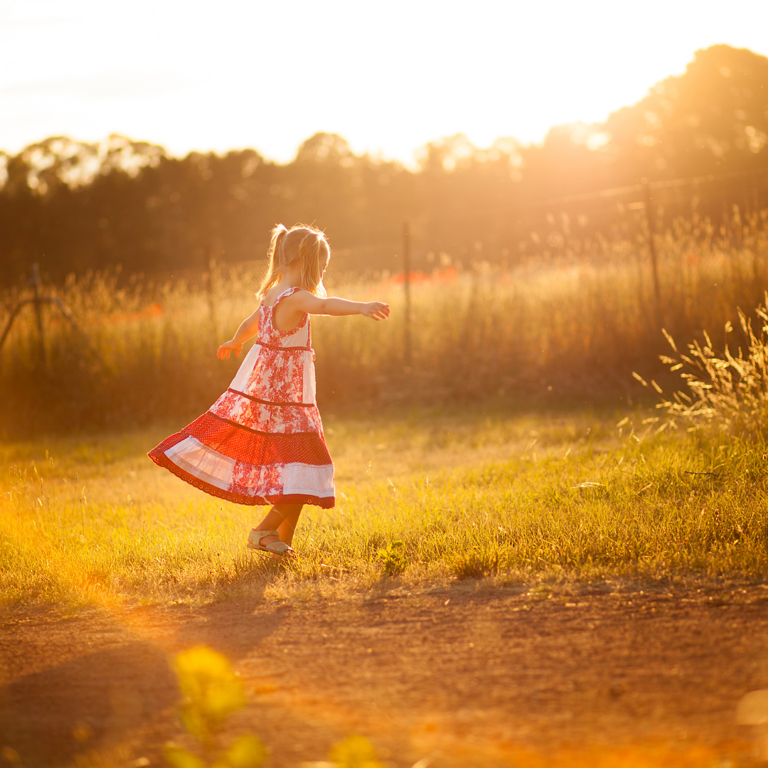 little girl twirling in a red and white dress