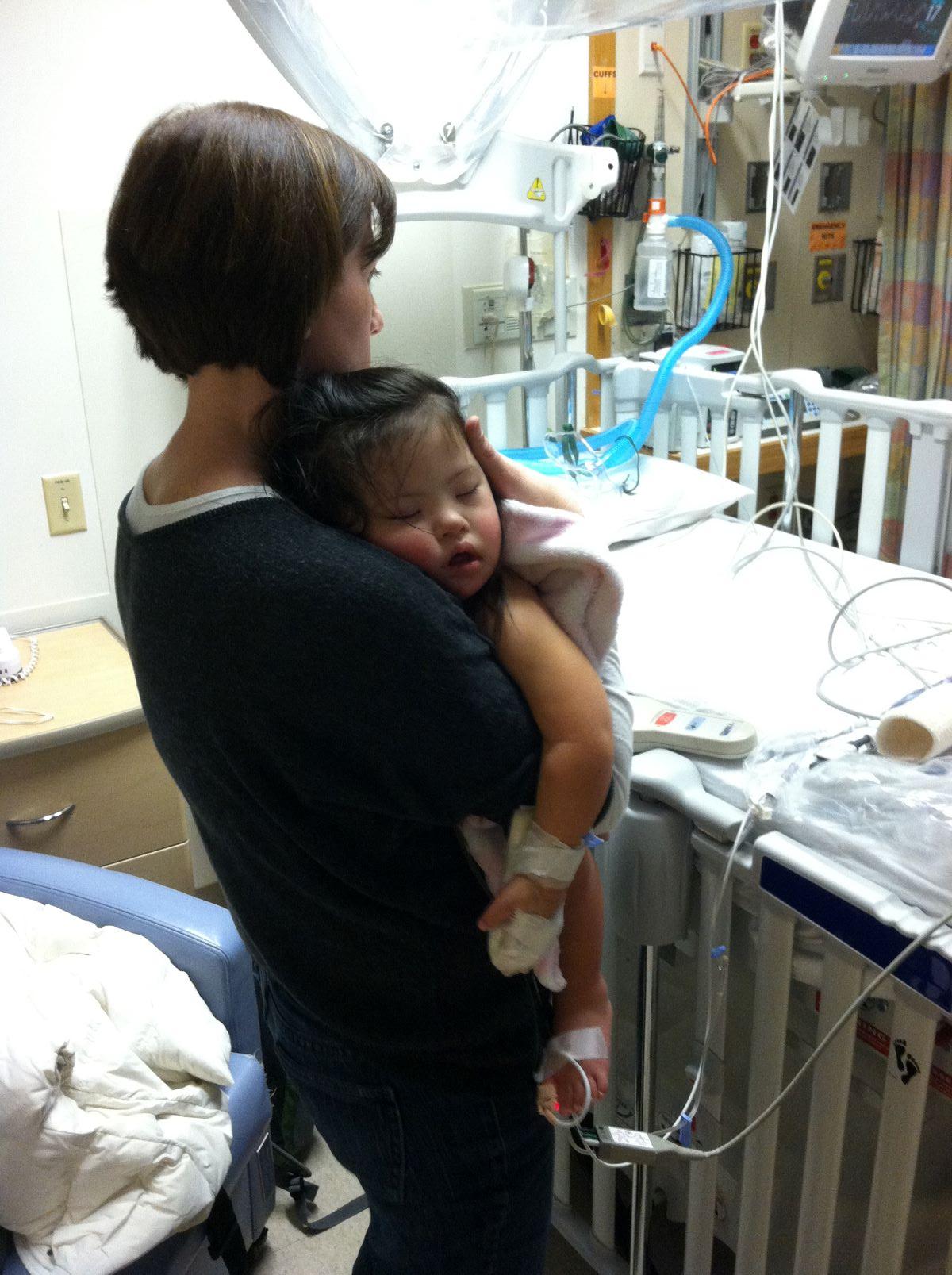 mother holding baby in hospital room