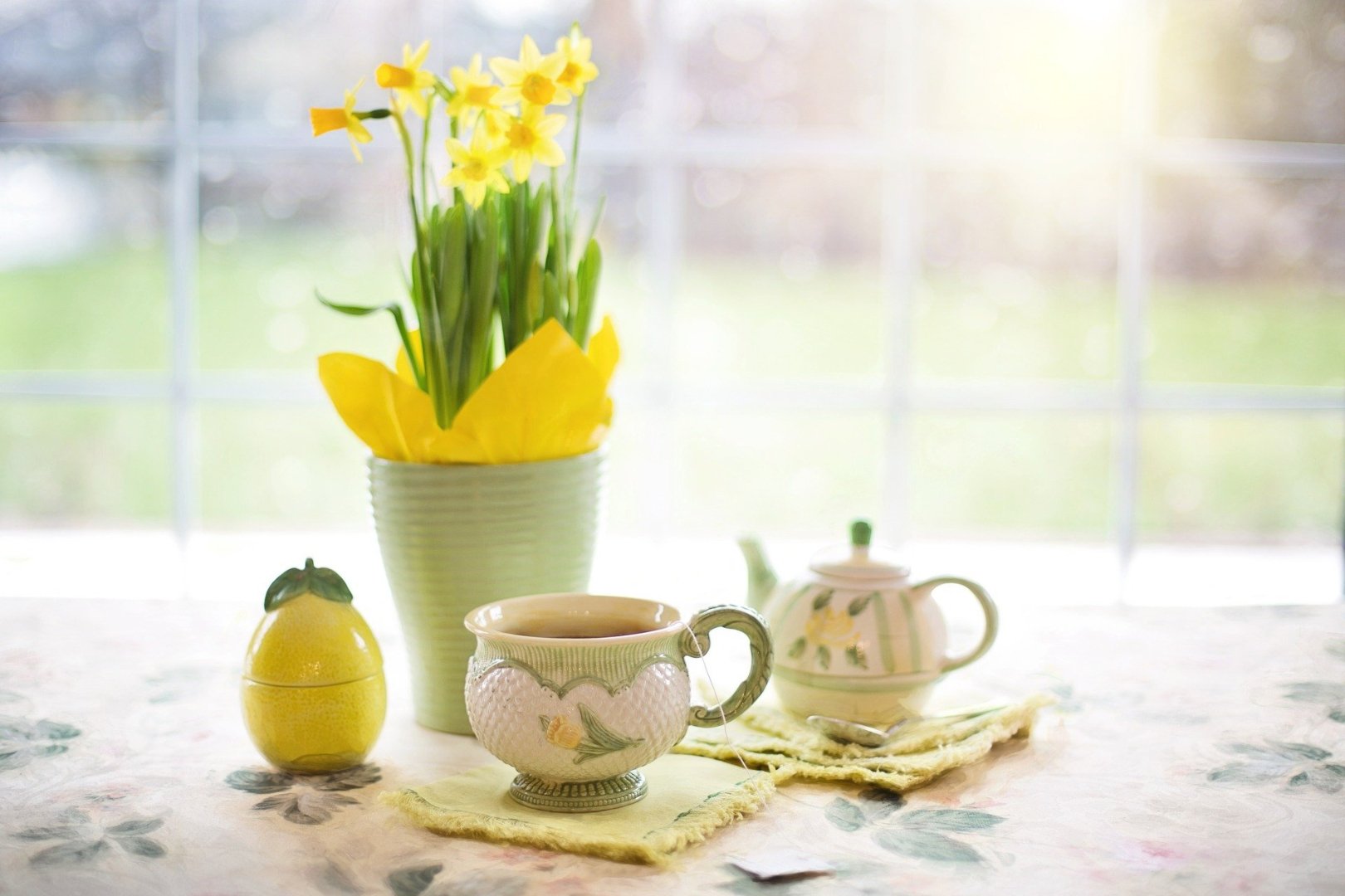 bouquet of daffodils with green and yellow tea service