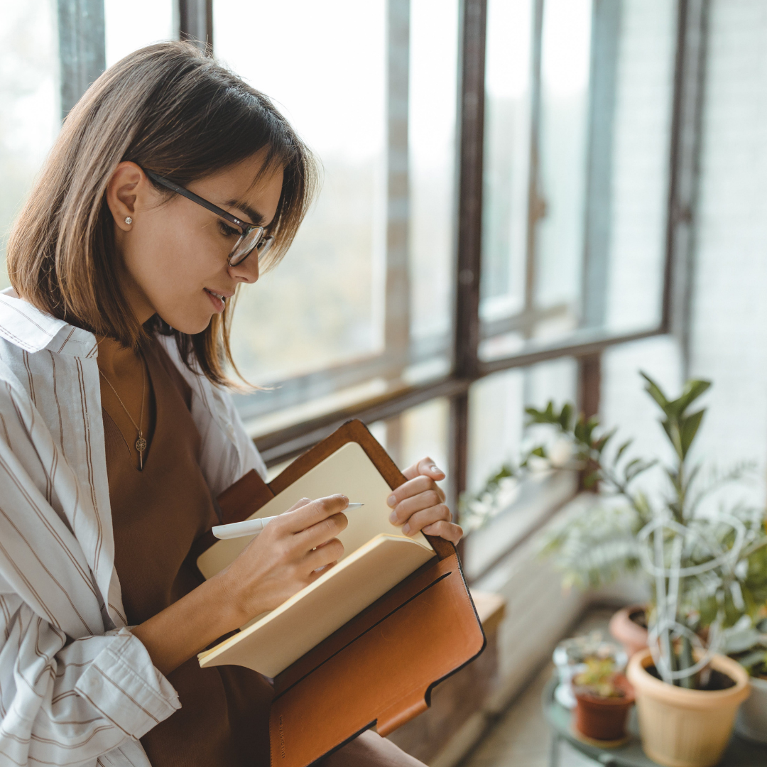 woman writing in journal