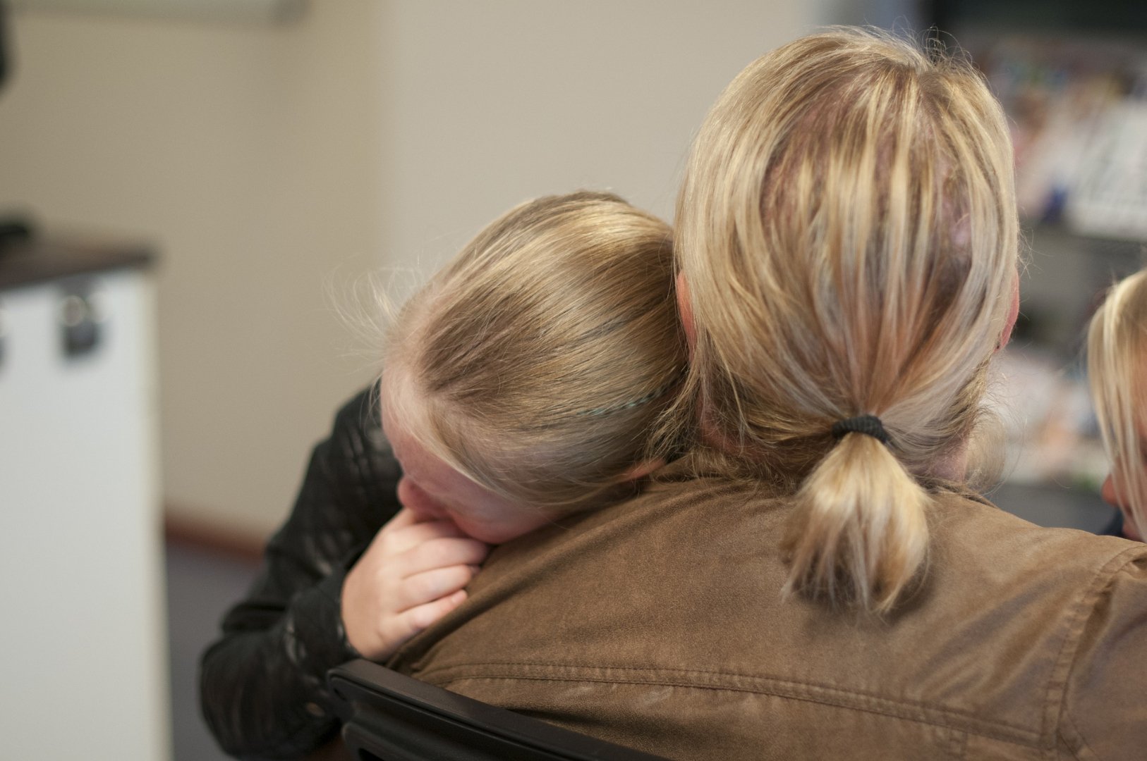 mother hugging young child