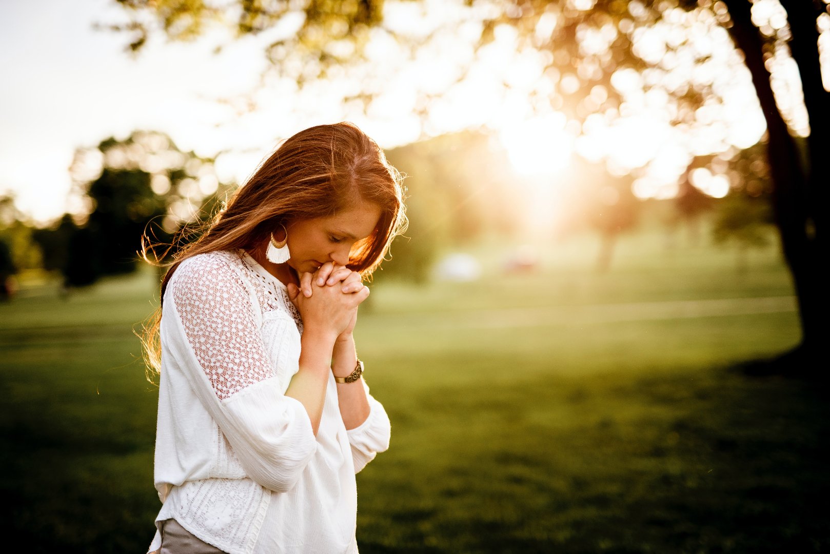 woman standing outside praying