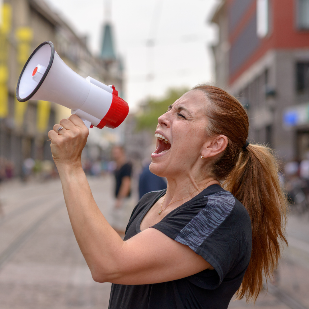 woman shouting into a bullhorn