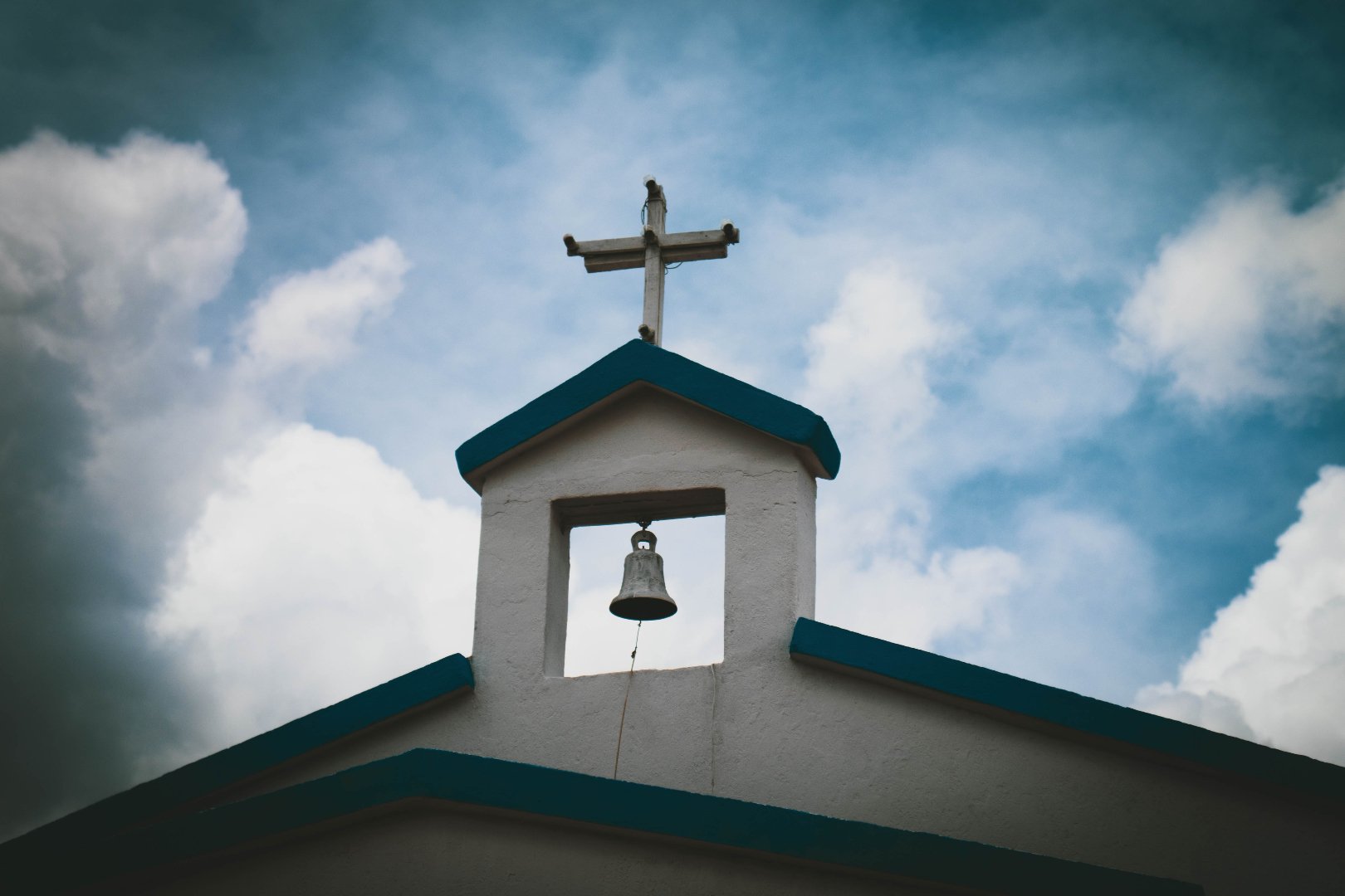 church steeple with bell and cross