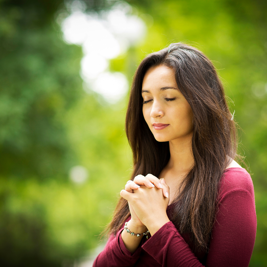 woman praying outdoors