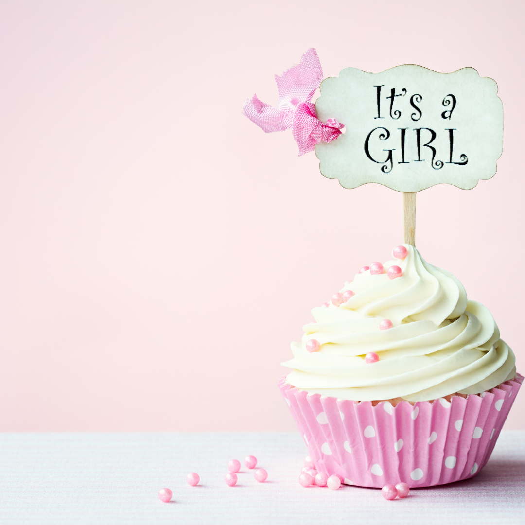 pink and white cupcake with "it's a girl" decoration