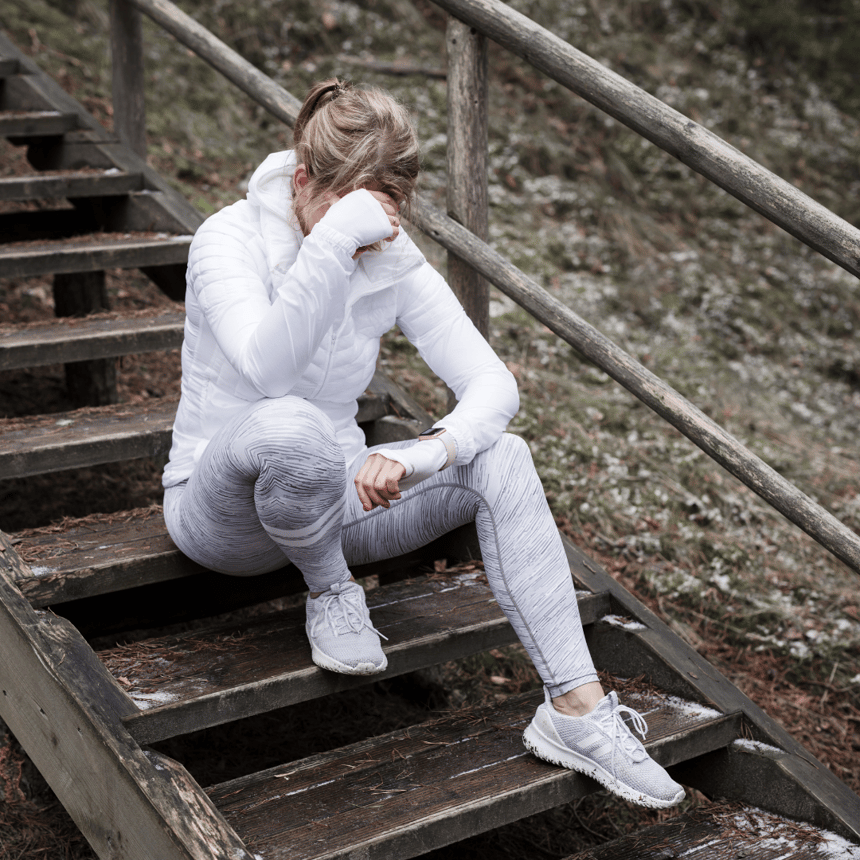 tired woman sitting on stairs