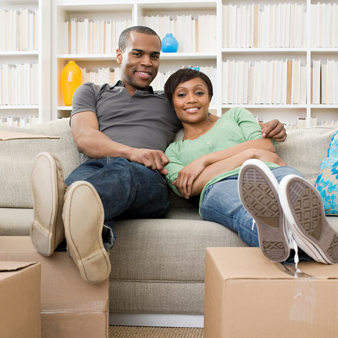 couple relaxing with feet on cardboard boxes