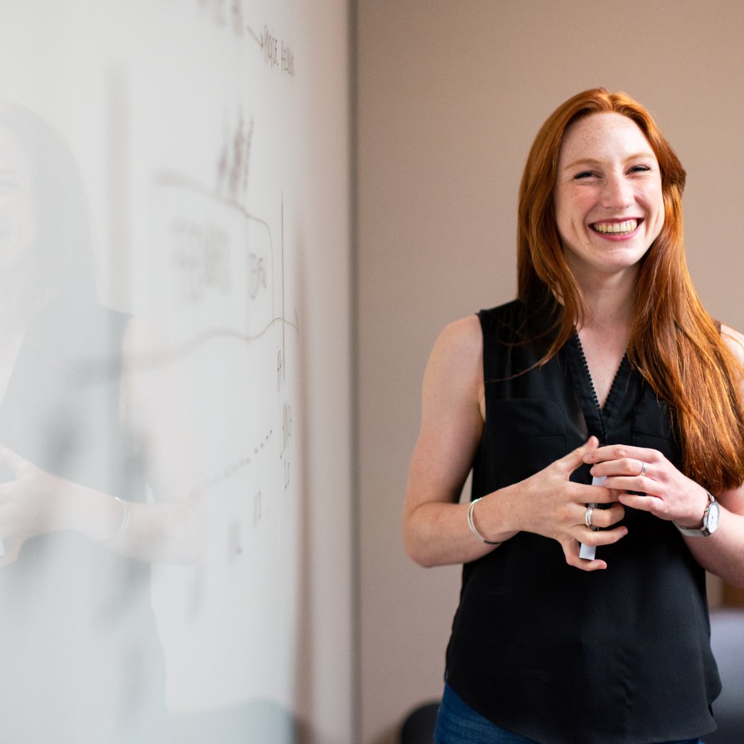 woman teaching a class in front of smartboard