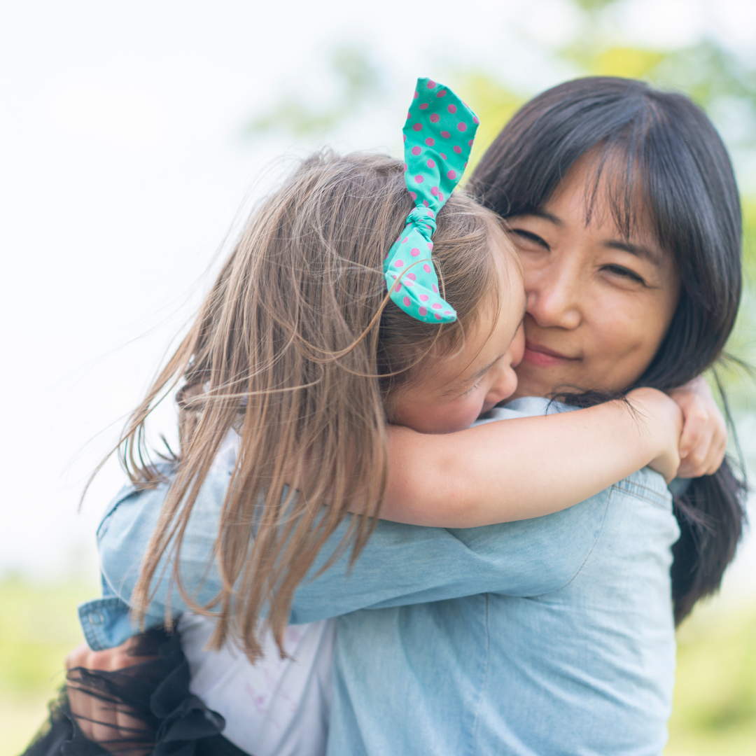 mom hugging little girl