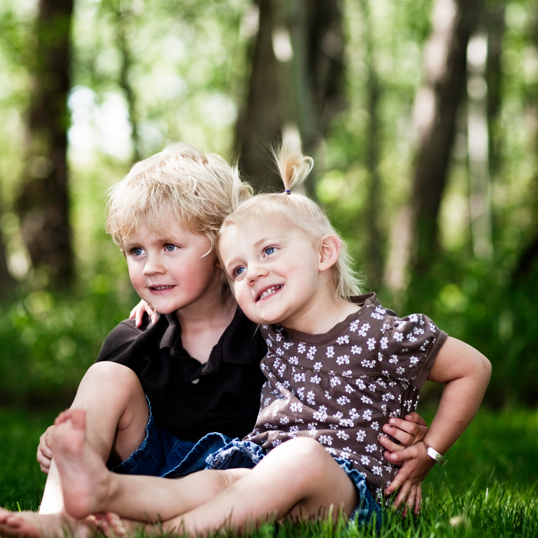 little sister eagerly hugging big brother