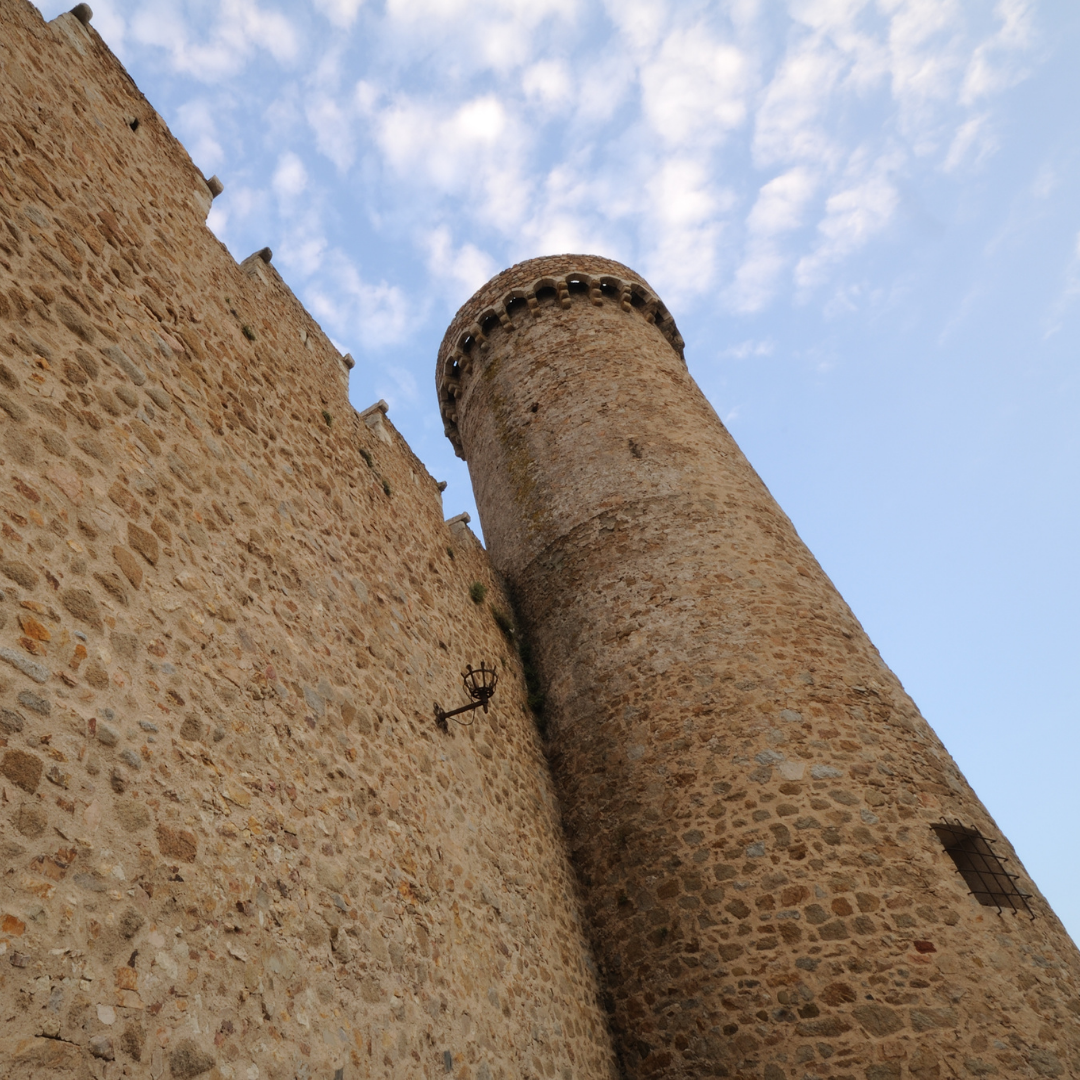 tall fortress wall and tower built of stone