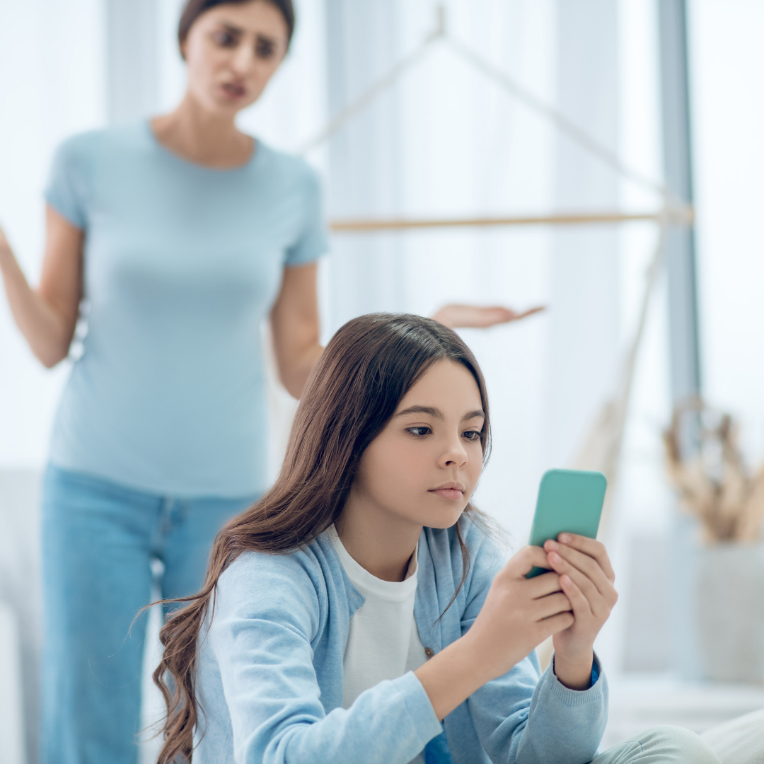 mom talking to daughter who's on phone and ignoring her