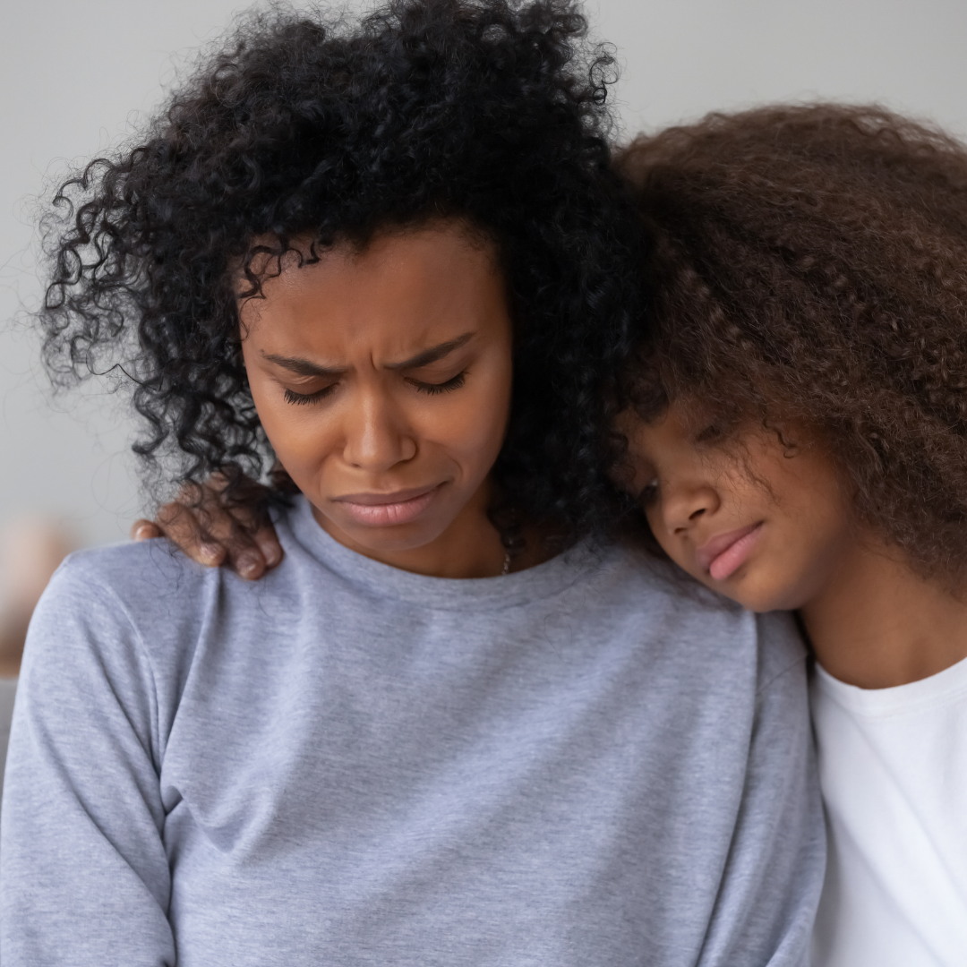 mom consoling sad daughter