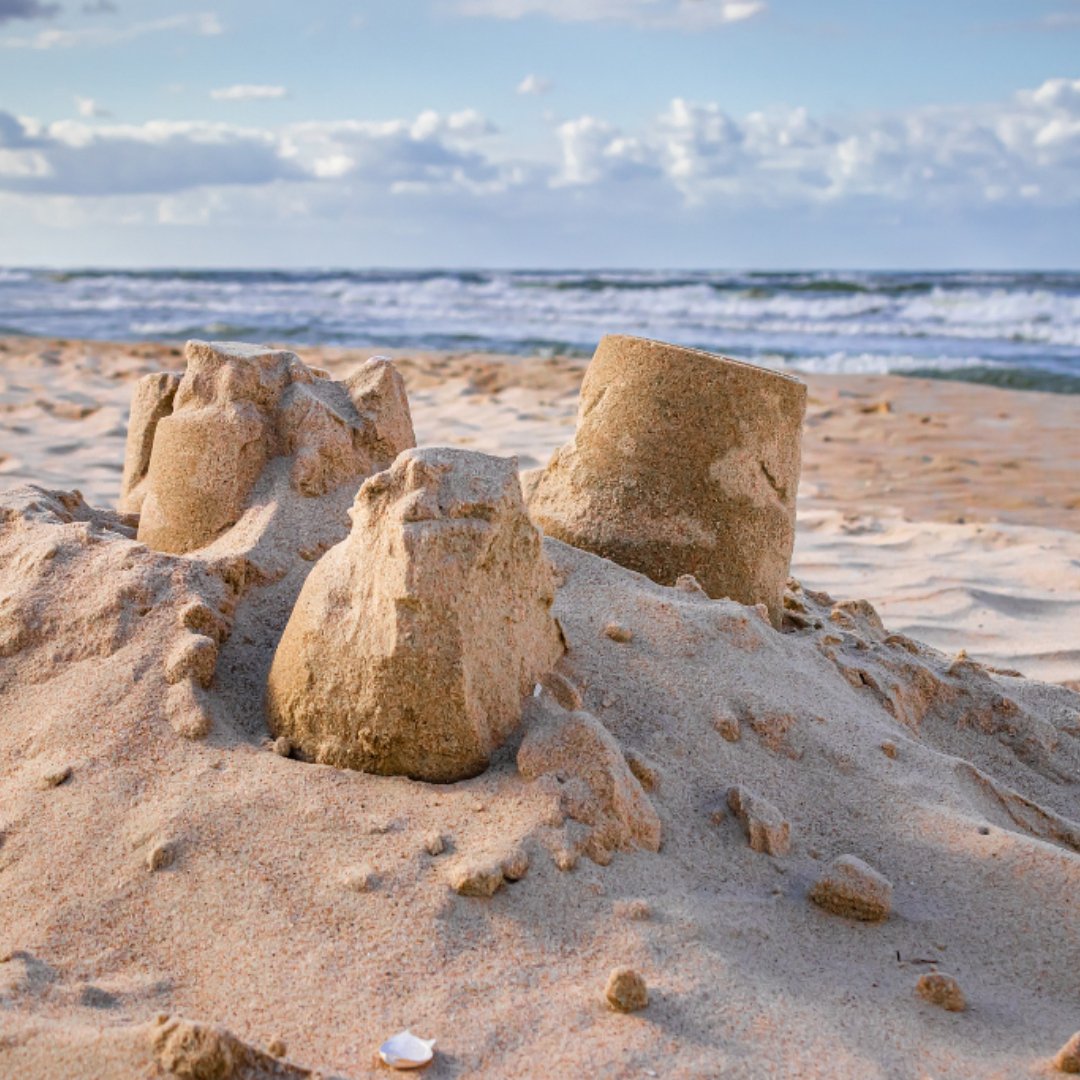 remains of a sand castle on the beach