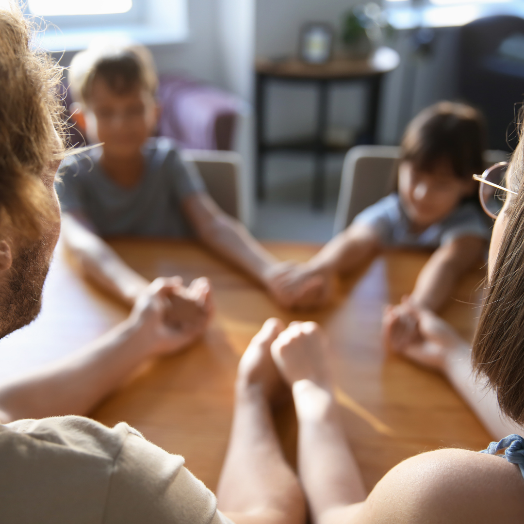 family holding hands in prayer