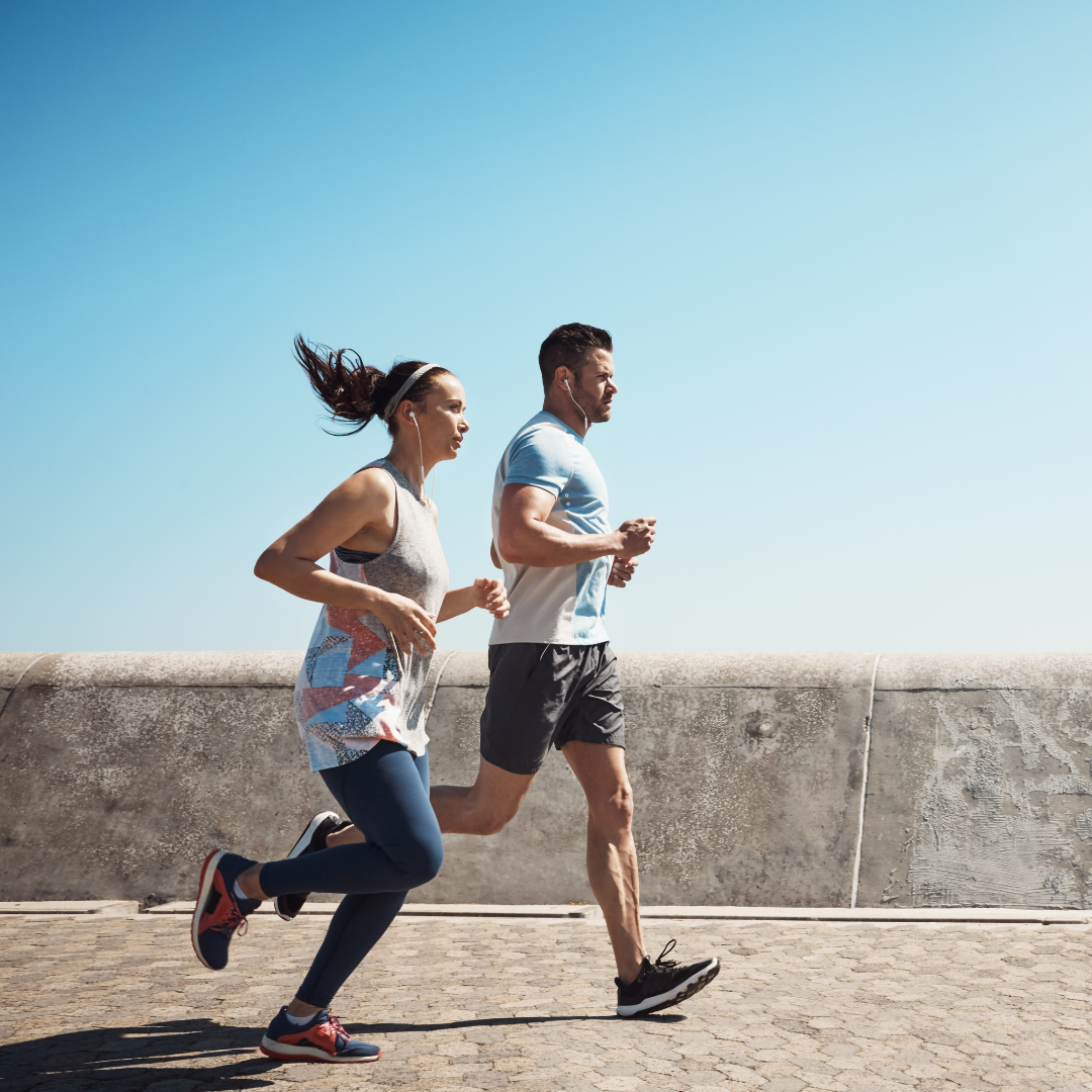 woman and man running on sidewalk