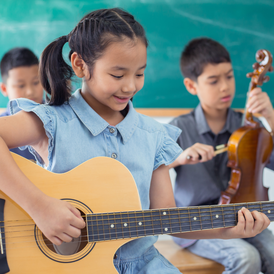 children learning to play guitar and violin