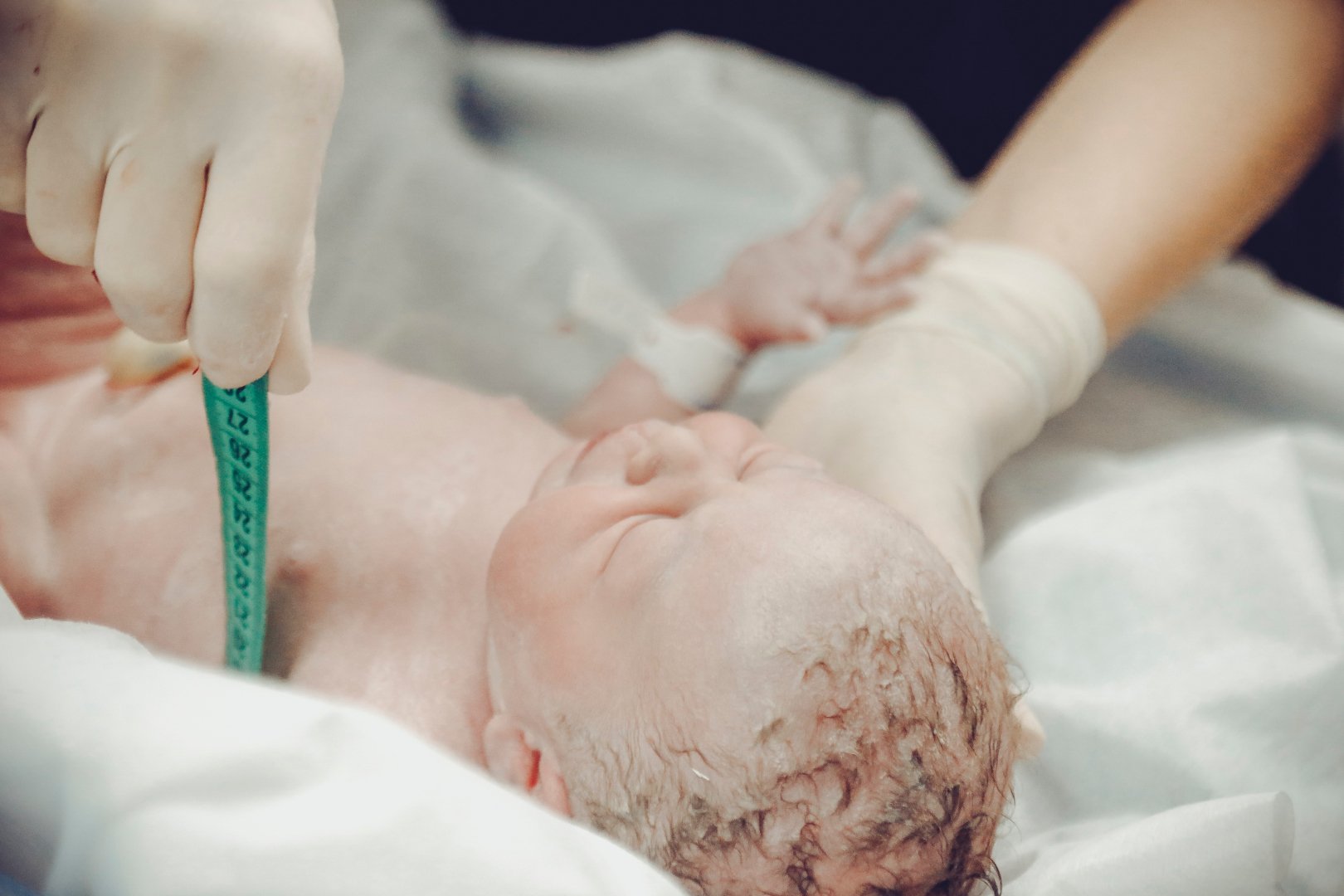 newborn baby being measured