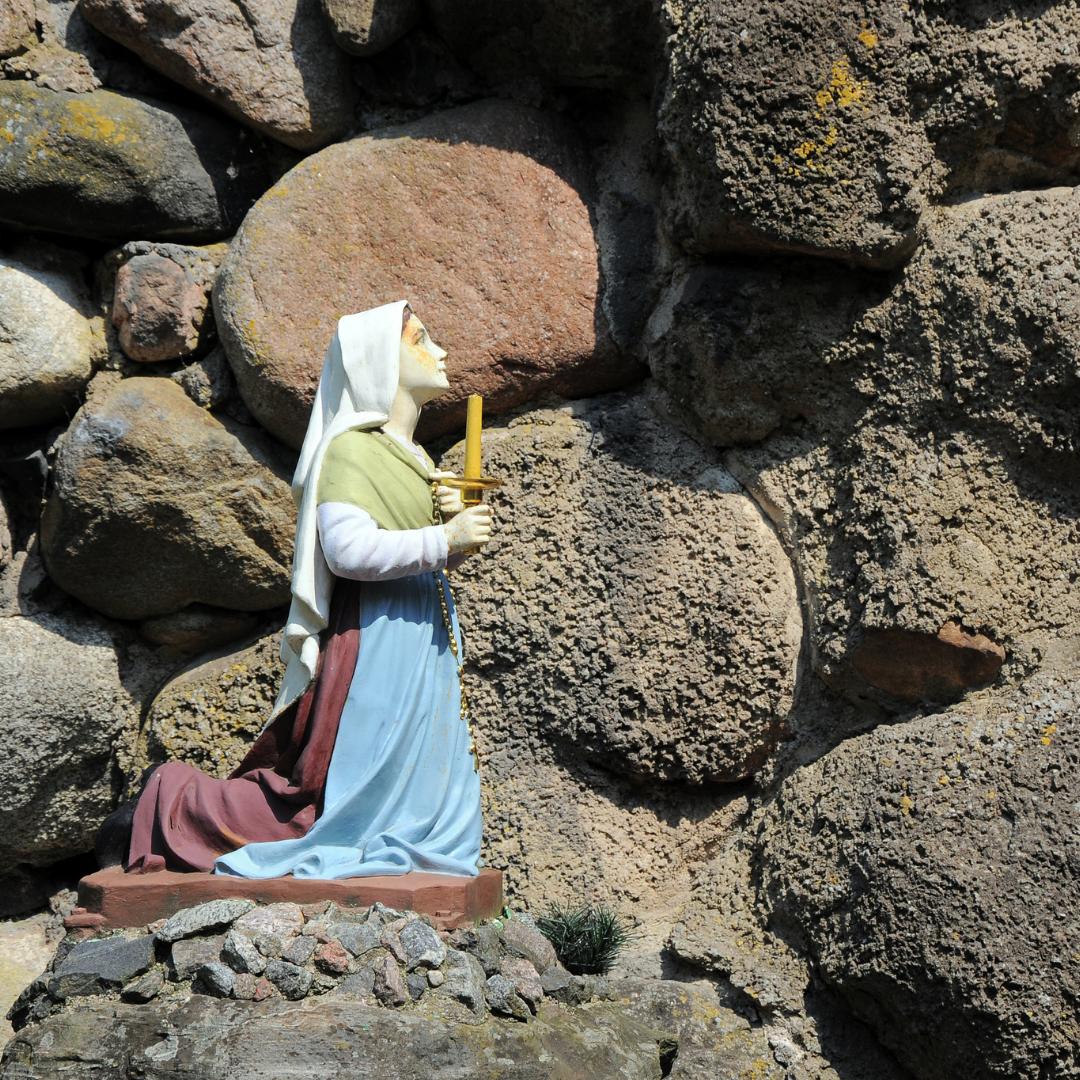 statue of St. Bernadette in a grotto