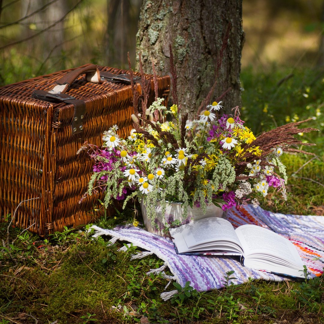 picnic basket, flowers, and open book