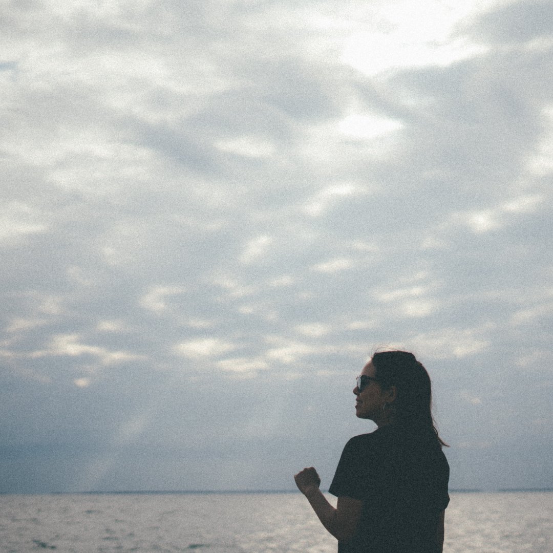 woman standing by seashore