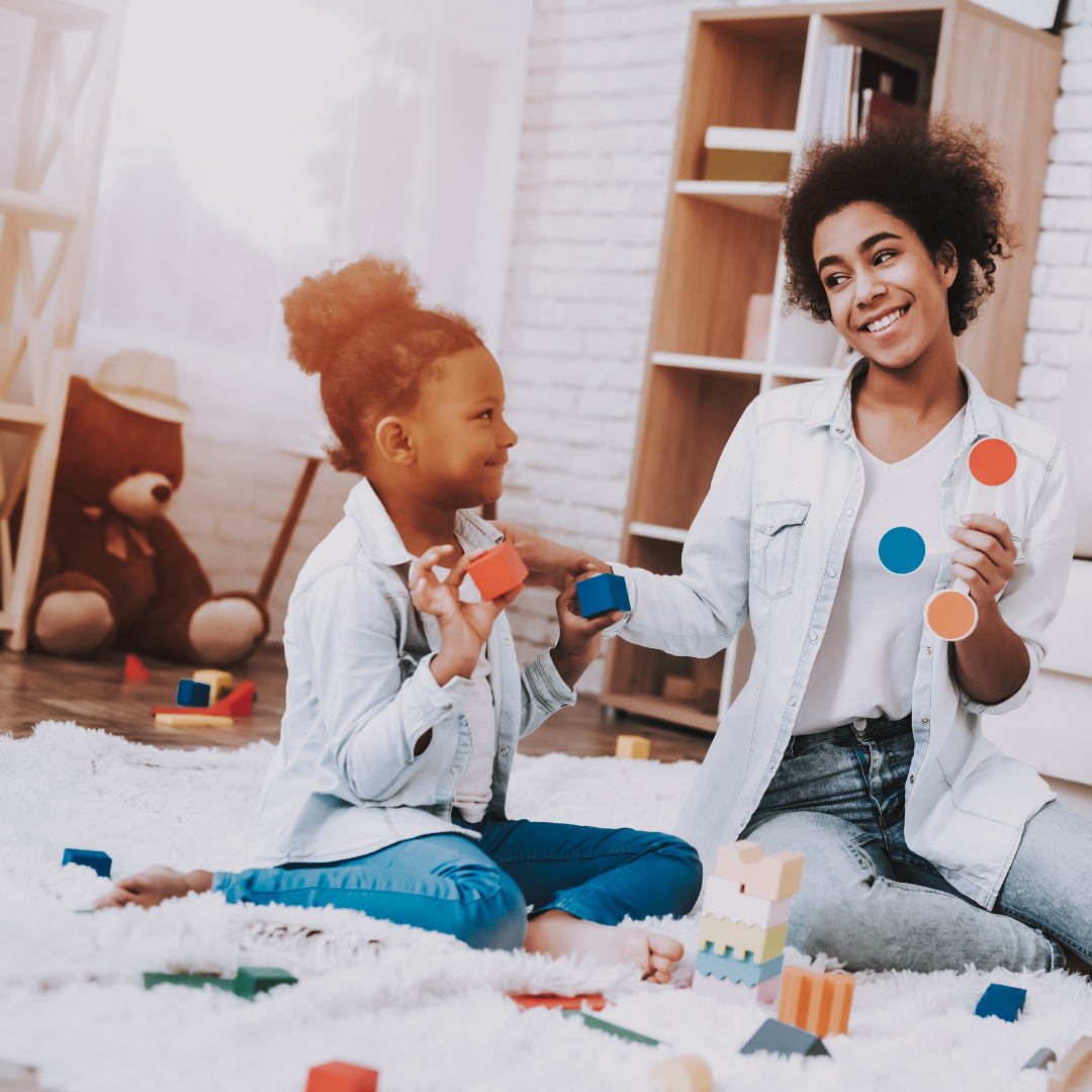 little girl and mom playing with blocks