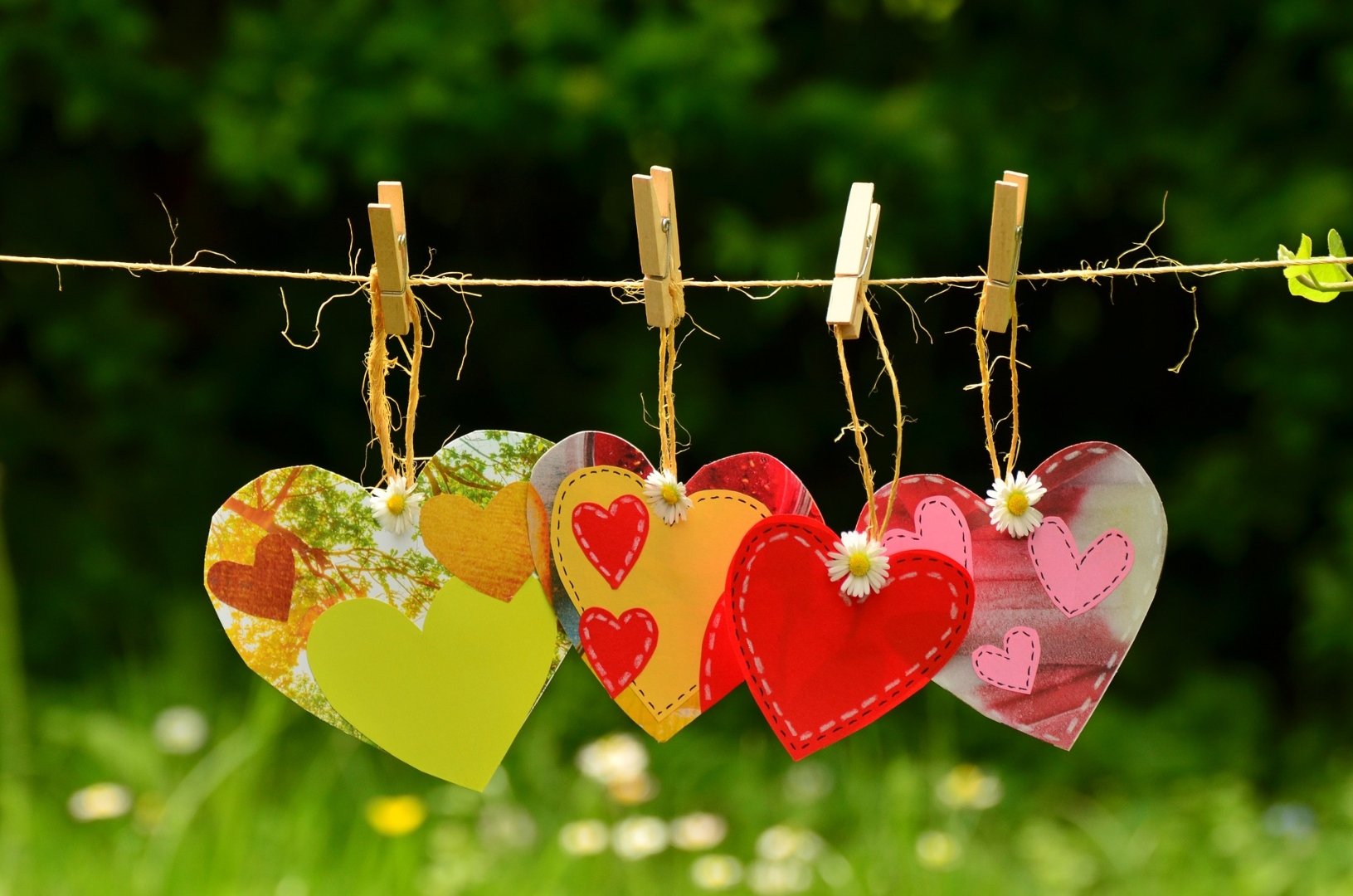 paper hearts hanging from a clothesline