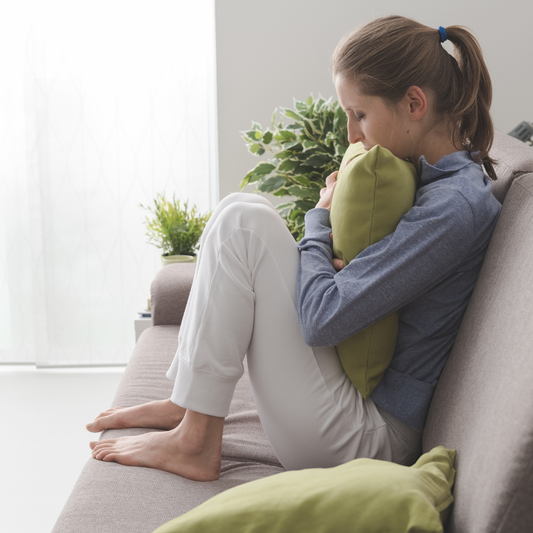 sad woman crying on couch