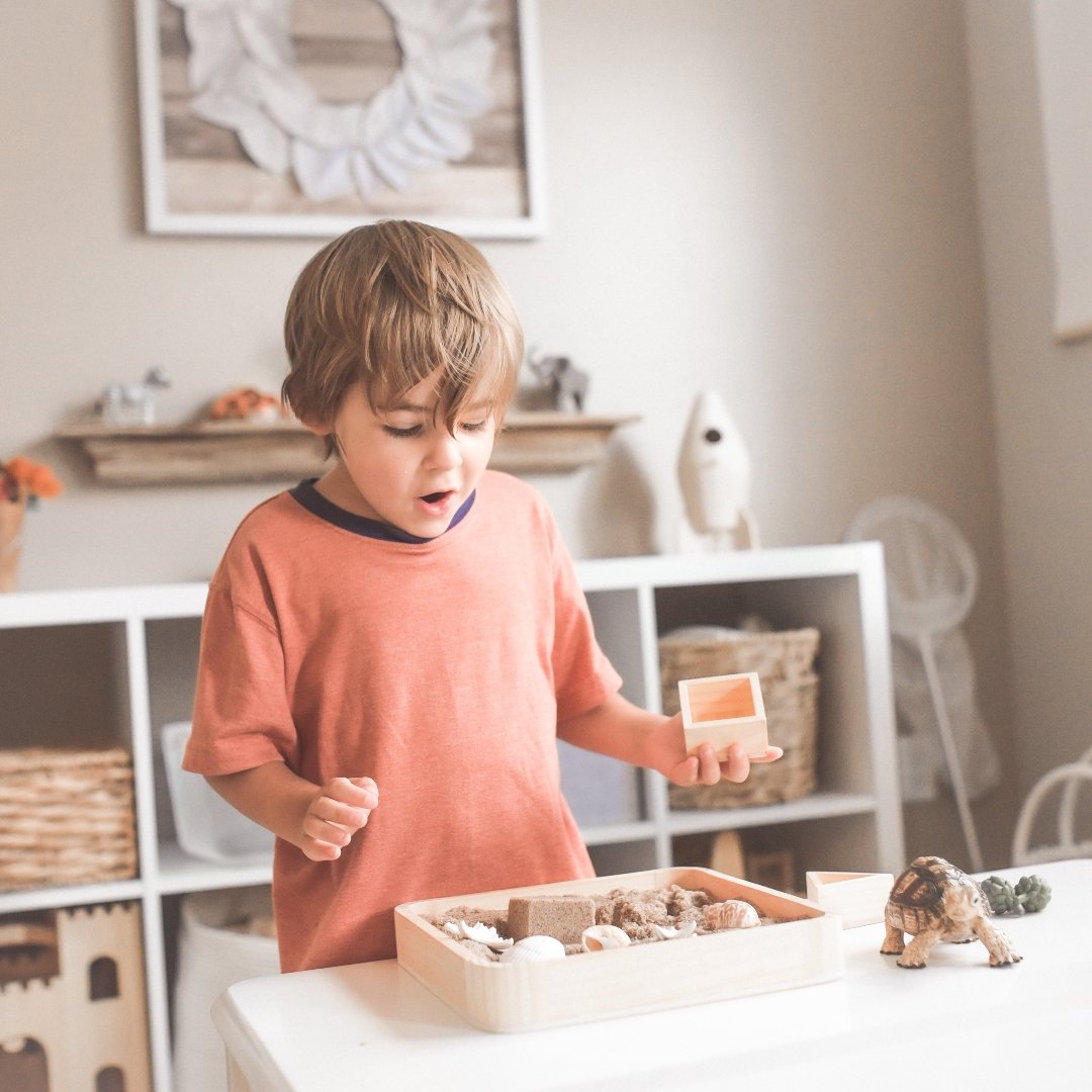 little boy playing with blocks and toy animals