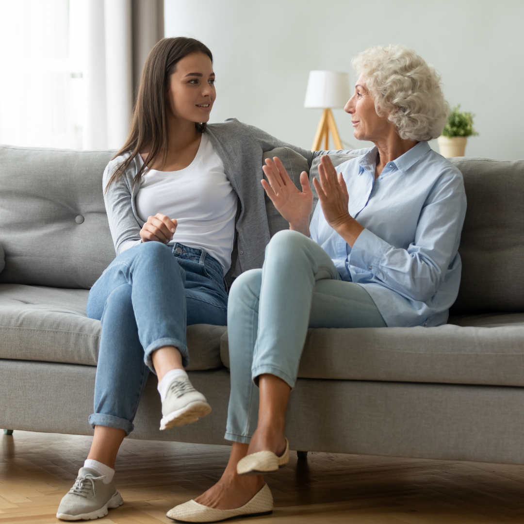 young woman talking with elderly woman