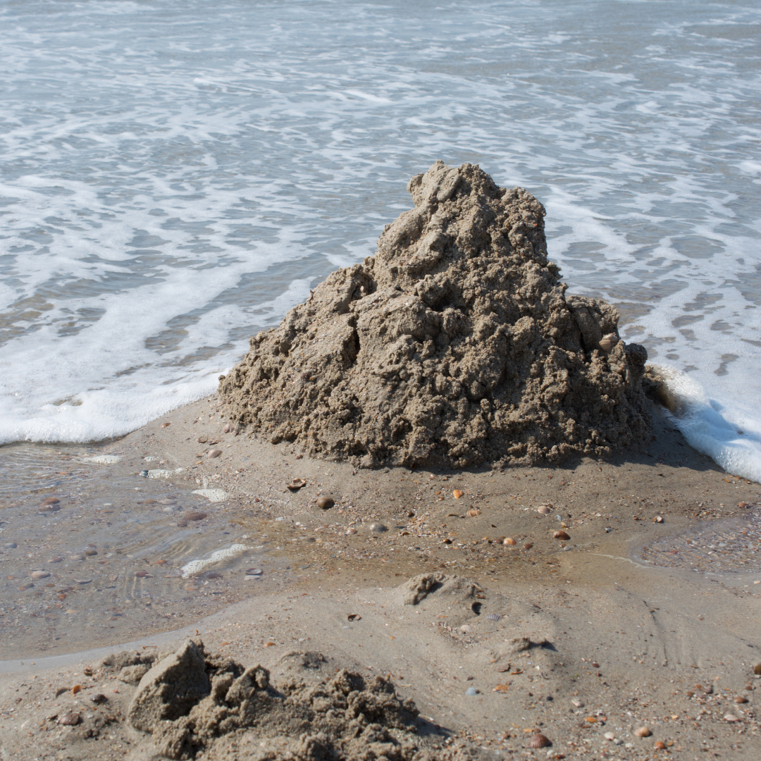 sand castle destroyed by a wave