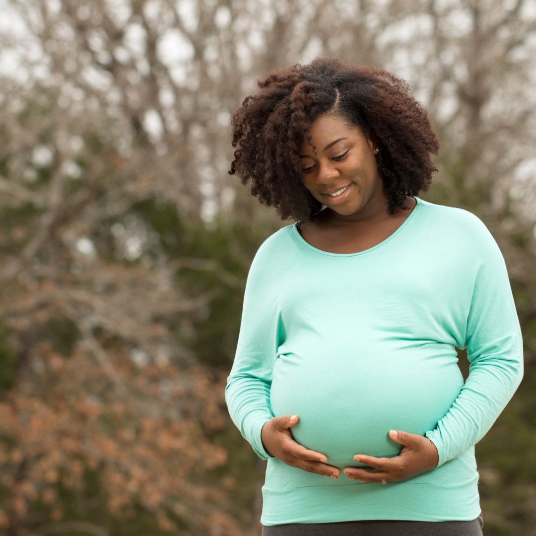 pregnant woman cradling belly