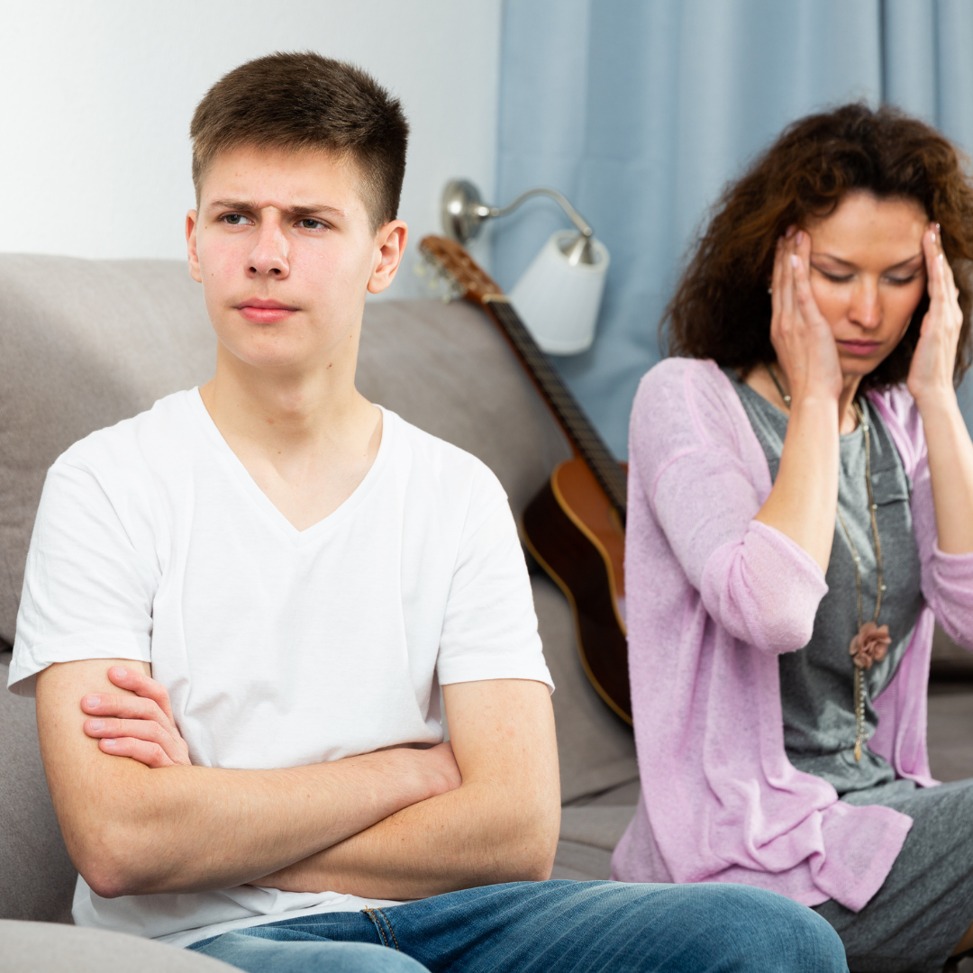 teenager ignoring mom, who has a headache and is worried