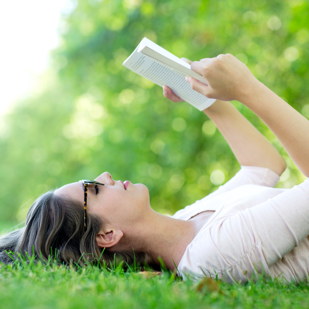woman reading in the grass