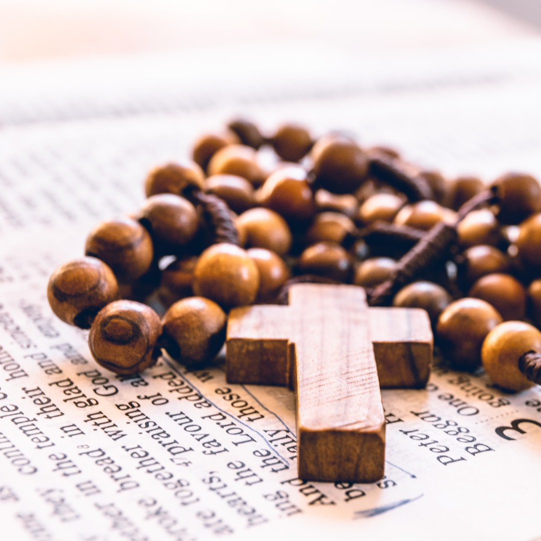 Rosary on top of open BIble