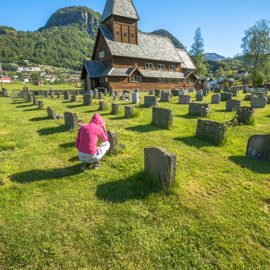 woman praying in cemetery