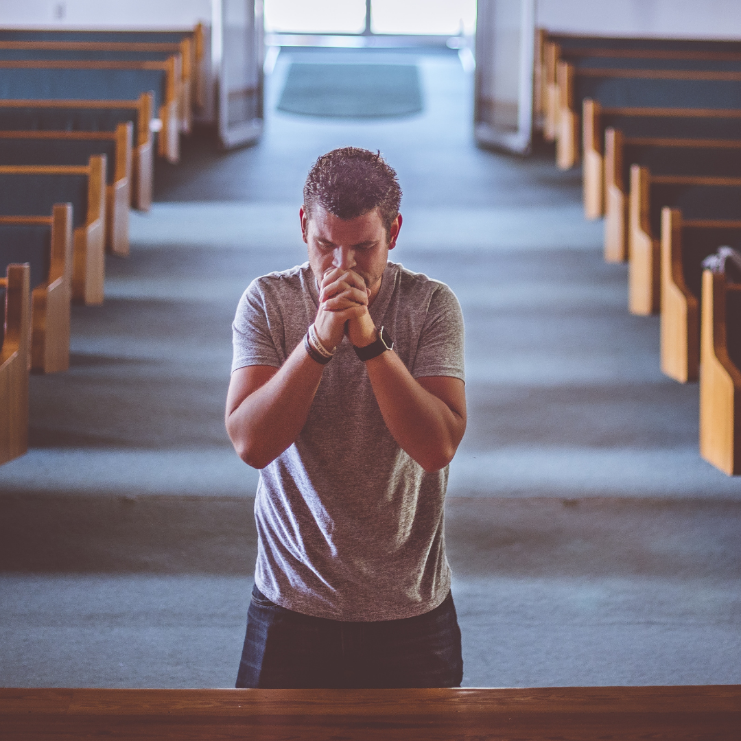 young man kneeling in church