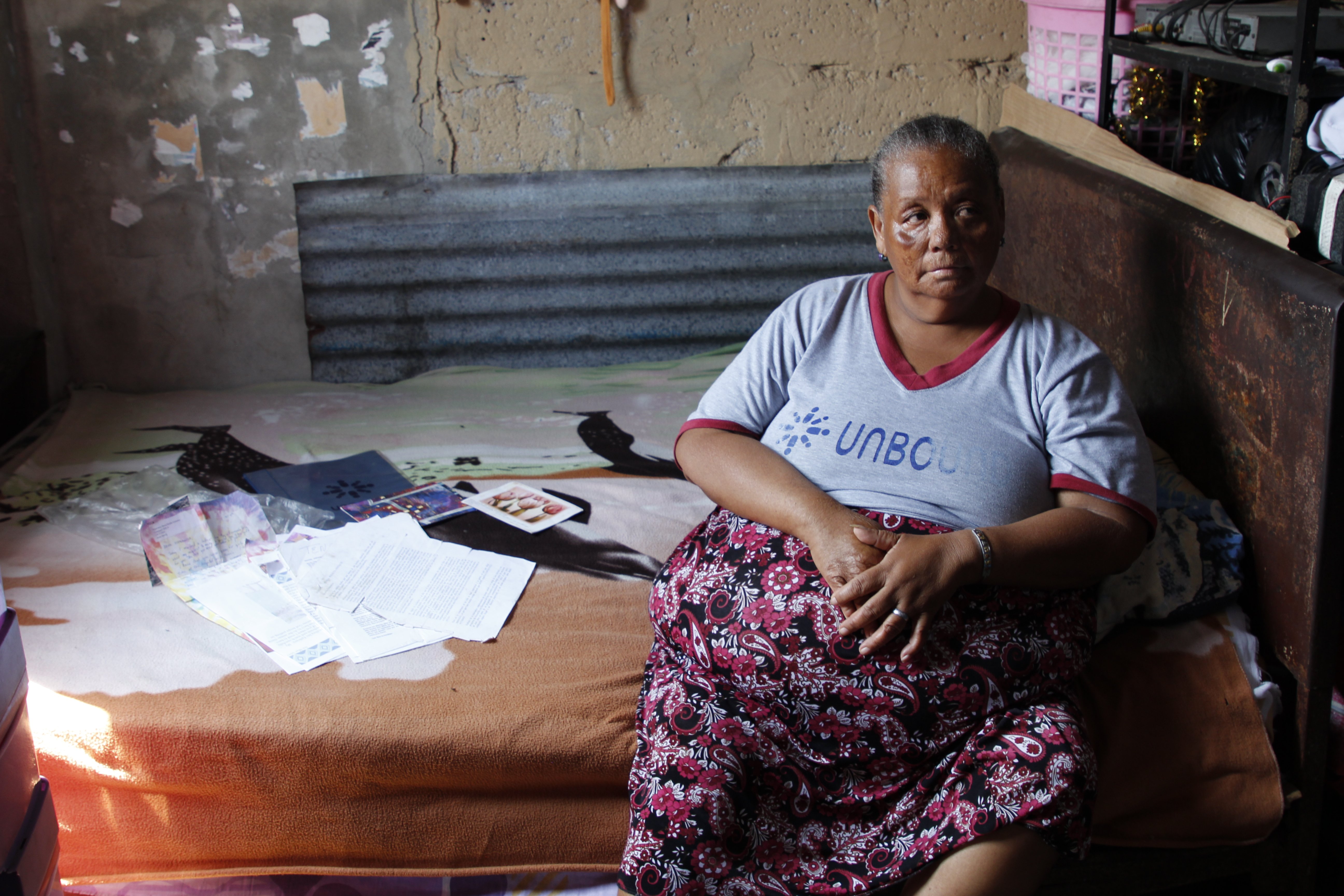Inside her home in Ecuador, sponsored elder Esperanza displays some of the letters she’s received over the years from her sponsor, Anne Harvey in Kansas. Esperanza says the letters are among her most valued possessions.