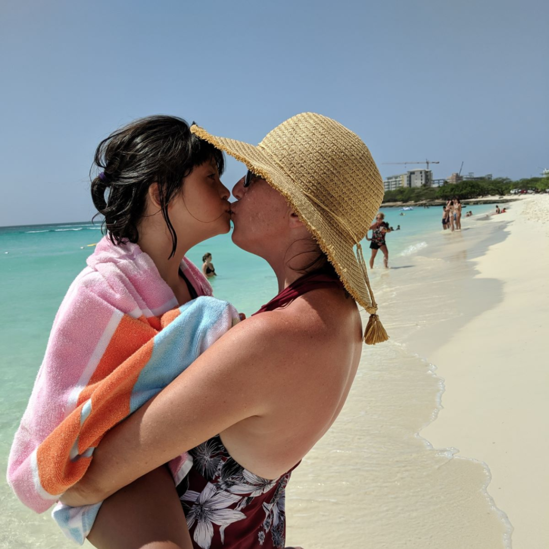 mom kissing her daughter