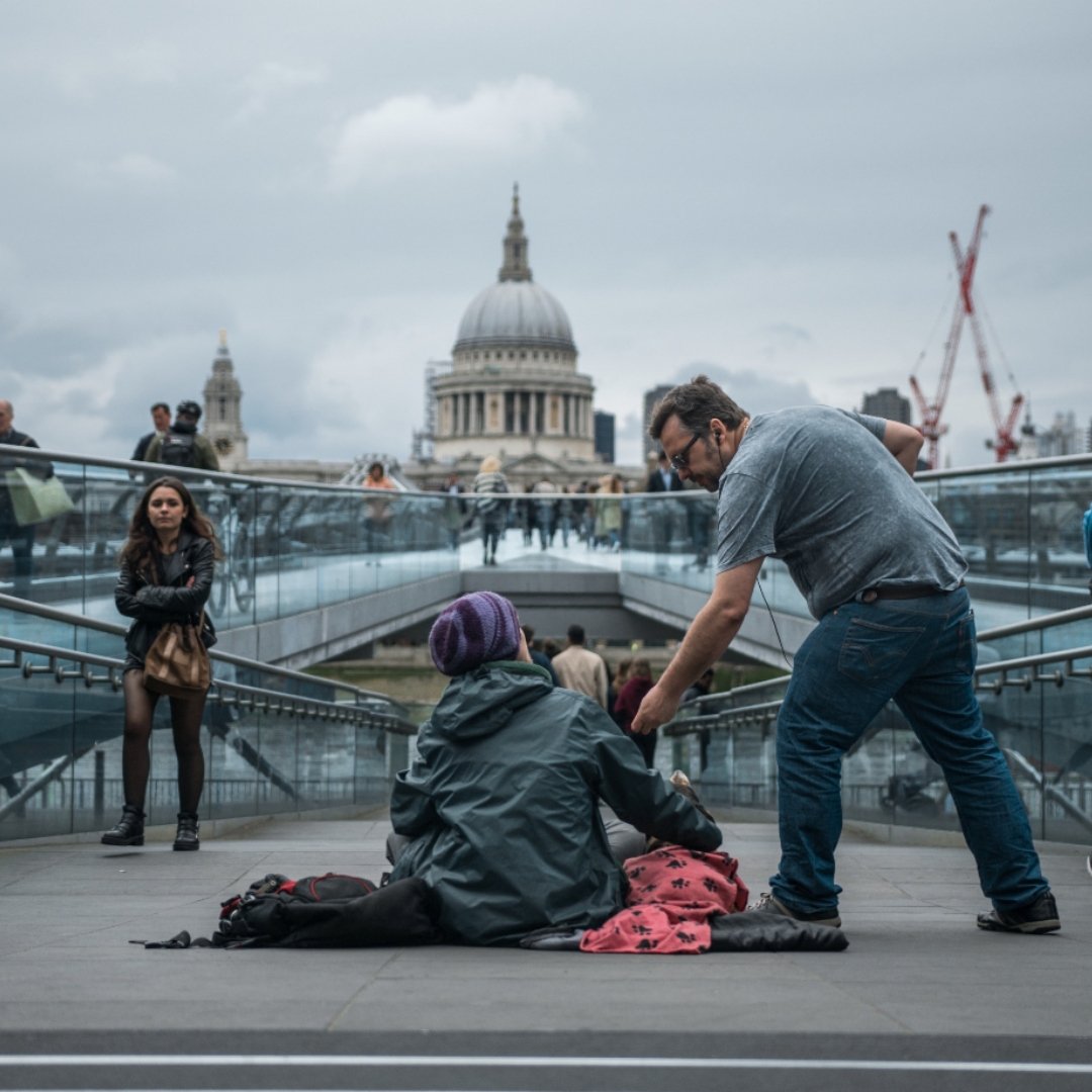 man helping homeless person