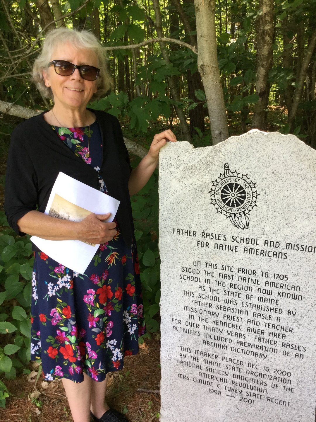 Kathryn Swegart standing next to historical marker about Fr. Rale