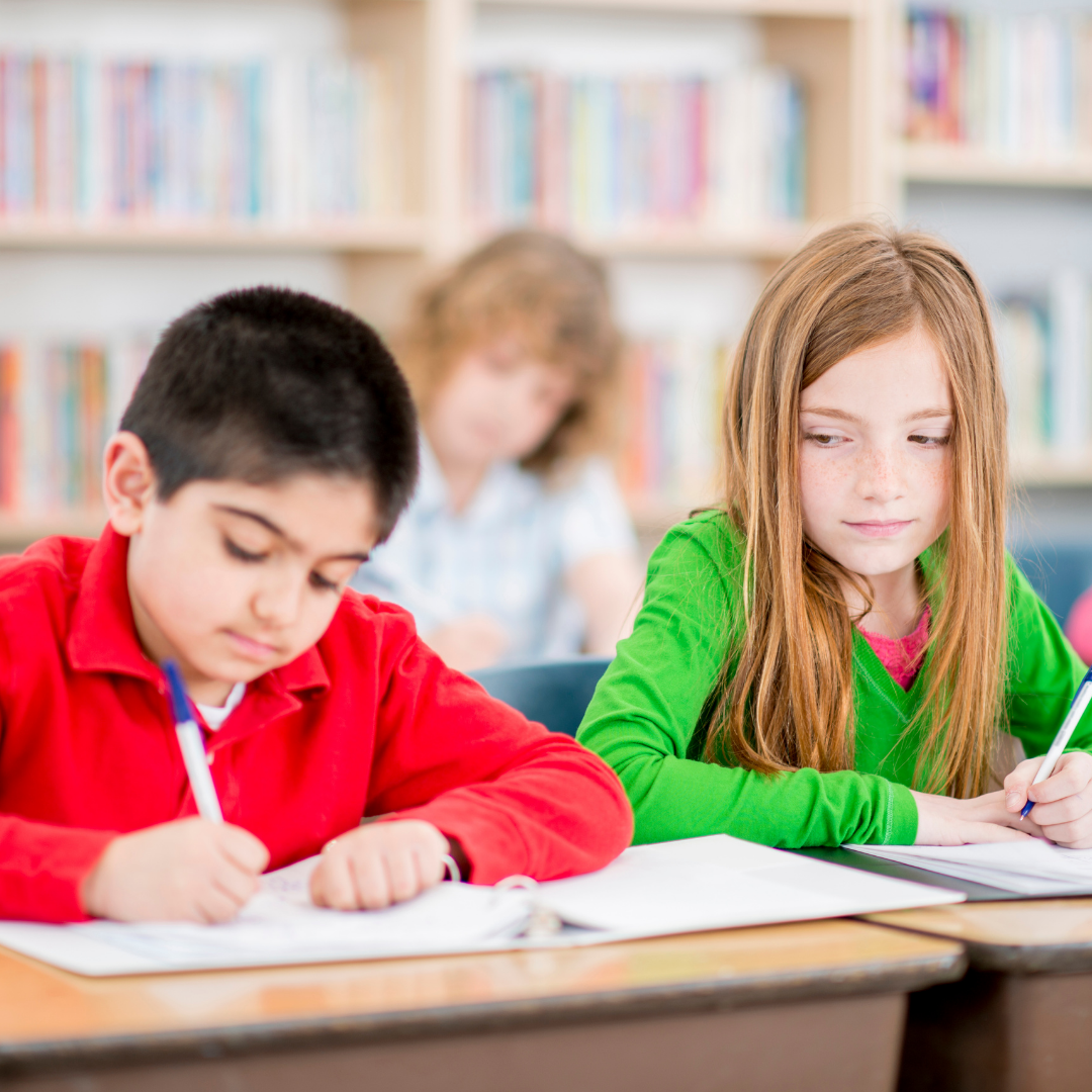 girl cheating off boy's paper in school