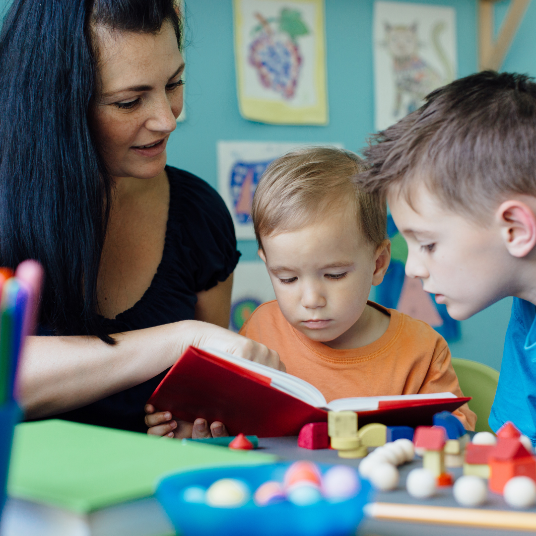 mom reading to 2 little boys