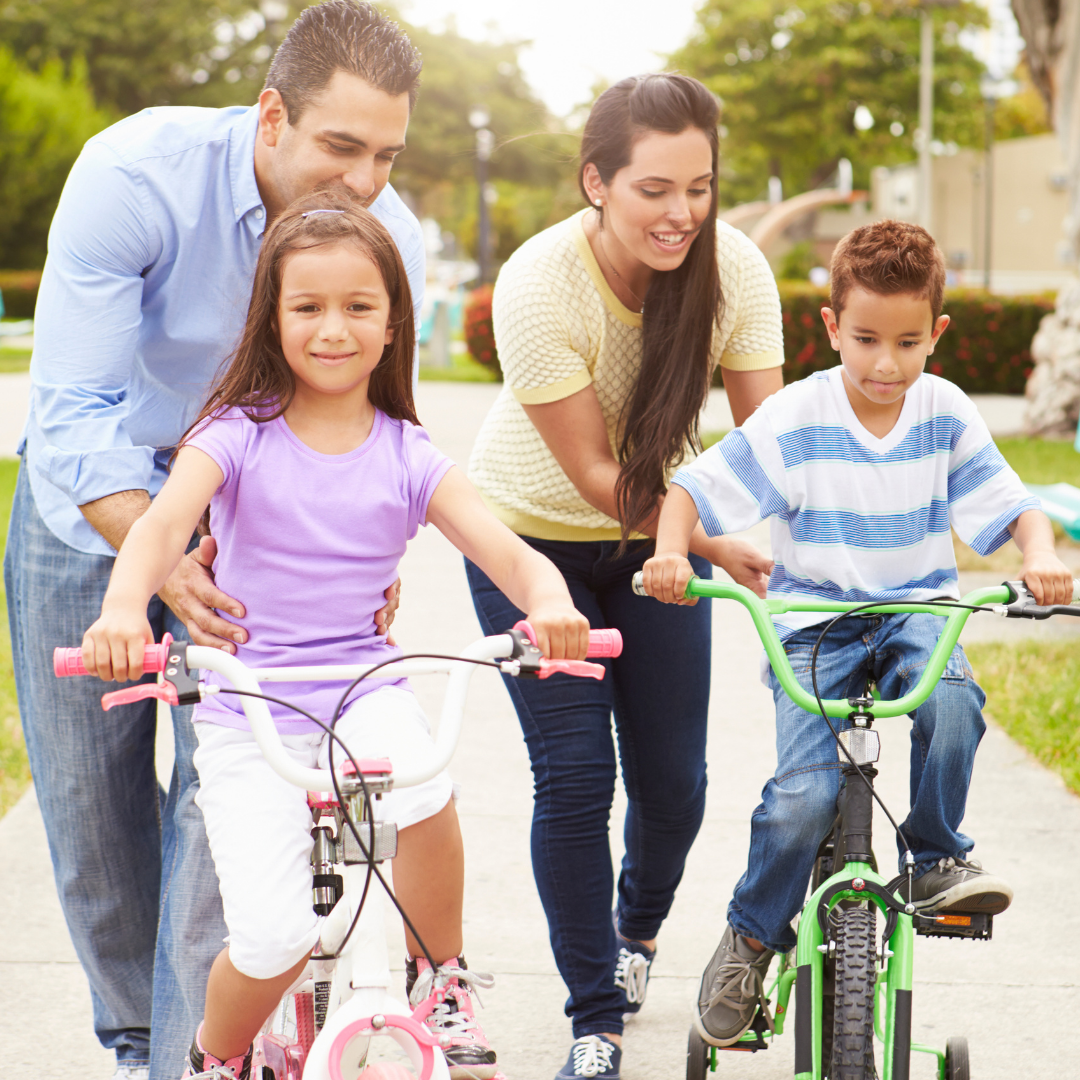 parents teaching children how to ride bikes